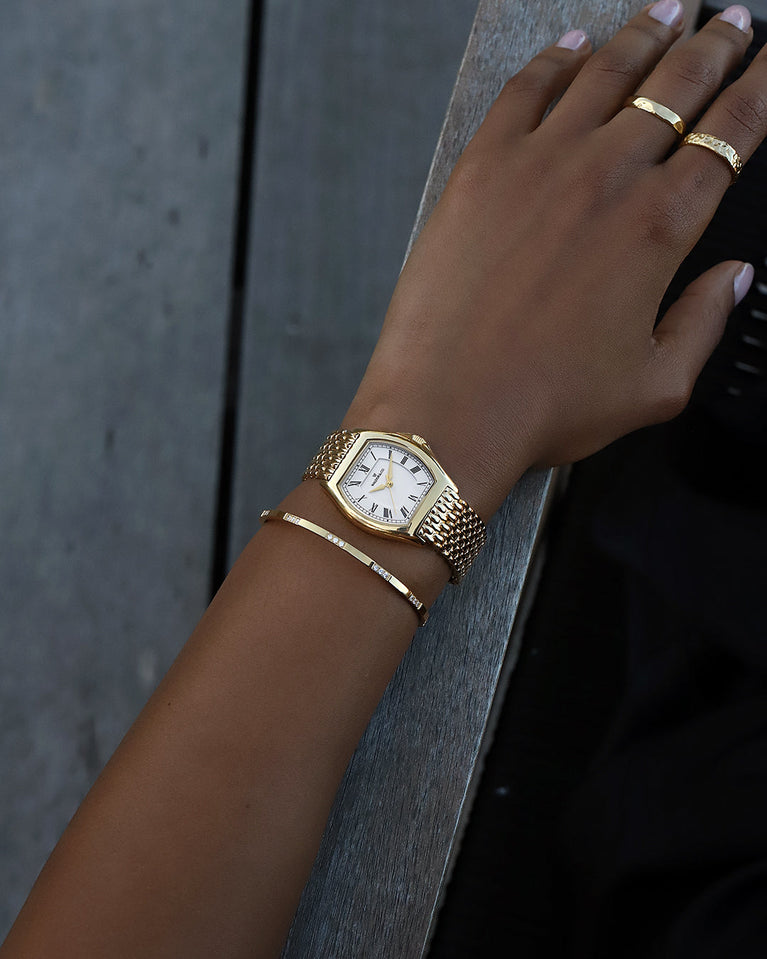 A square womens watch in 22k gold plated 316L stainless steel from Waldor & Co. with domed mineral glass dial. Seiko movement. The model is Constant 36 Menaggio.
