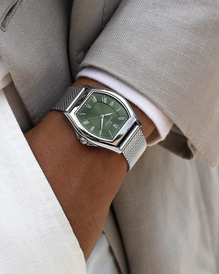 A tonneau mens watch in rhodium-plated silver from Waldor & Co. with green sunray dial and a second hand. Ronda movement. The model is Constant 40 Lecco.