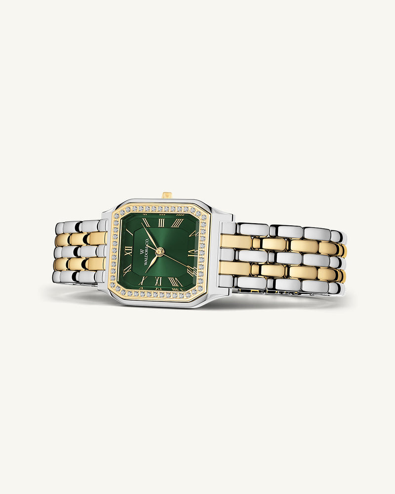 A square womens watch in Rhodium-plated 316L stainless steel from Waldor & Co. with emerald green dial. Bezel with premium crystals. Diamond Cut Sapphire Crystal glass dial. Seiko movement. The model is Eternal 22 Bellagio Pavè.