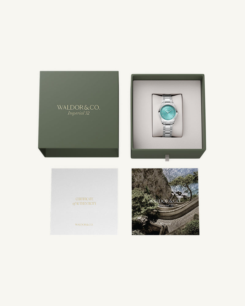 A round womens watch in silver from Waldor & Co. with turquoise sunray dial and a second hand. Seiko movement. The model is Imperial 32 Nocelle 32mm.