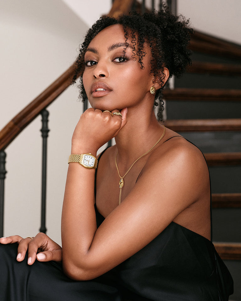 Earrings in gold plated-316L stainless steel from Waldor & Co. The model is Dual Knot Earring Polished.