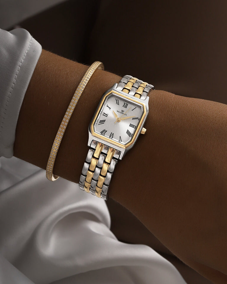 A square womens watch in 22k gold plated 316L stainless steel from Waldor & Co. with white Diamond Cut Sapphire Crystal glass dial. Seiko movement. The model is Eternal 22 Bellagio