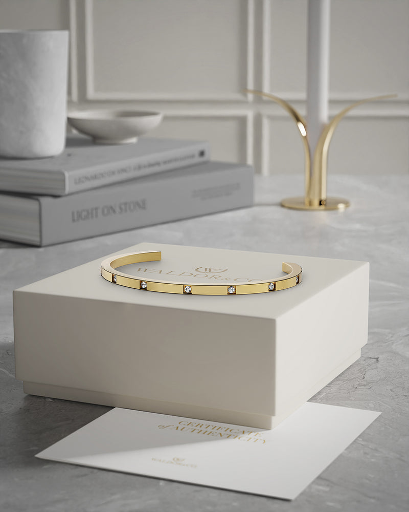 A Bangle Bracelet in 14k gold-plated stainless steel from Waldor & Co. The model is Brilliant Bangle Polished.