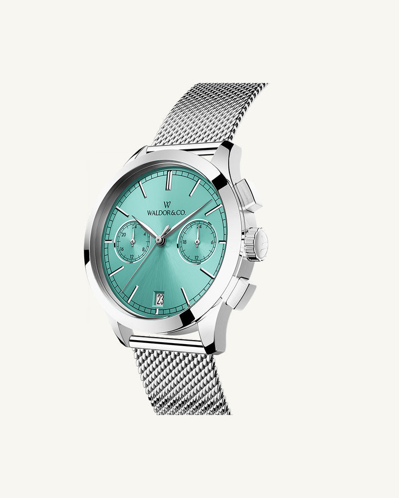 A round womens watch in rhodium-plated silver from Waldor & Co. with turquoise sunray dial and a second hand. Seiko movement. The model is Chrono 36 Sardinia 36mm.