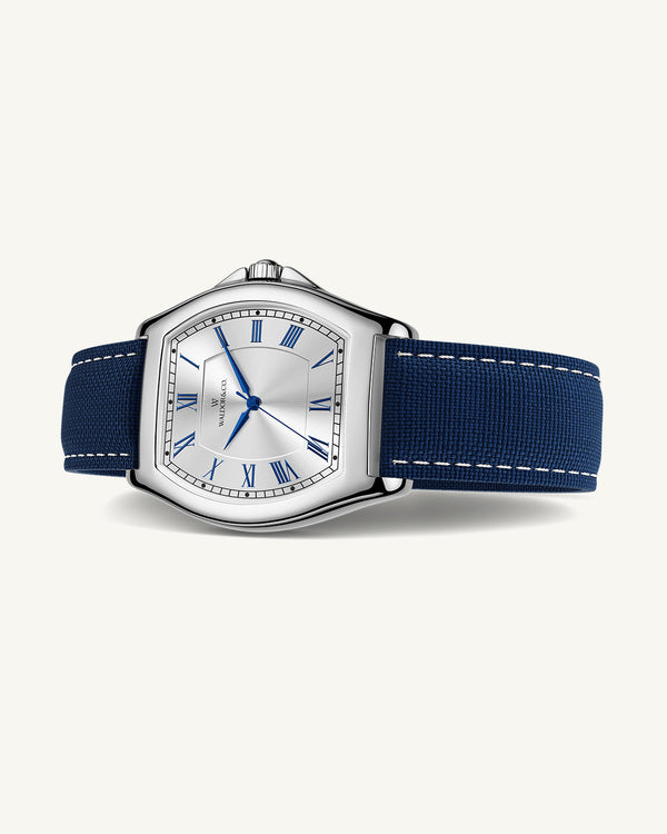 A square mens watch in Rhodium-plated 316L stainless steel from Waldor & Co. with white dial. Blue sailcloth strap. Ronda movement. The model is Constant 40 Tremezzo 37x45mm.