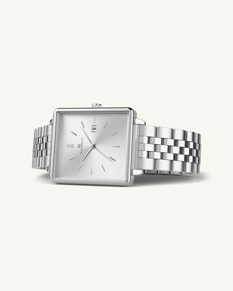 A square womens watch in silver from WALDOR & CO. with silver sunray dial and a second hand. The model is Delight 32 Chelsea 28x32mm.