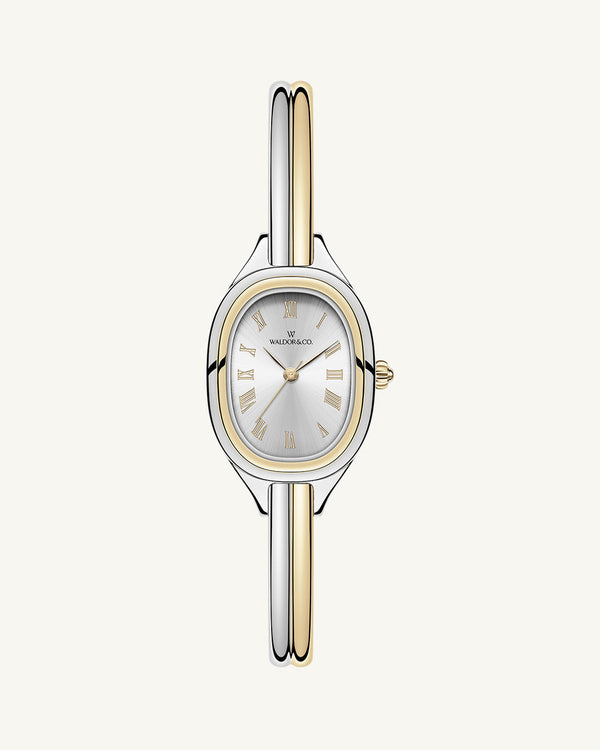 An ellipse shaped womens watch in Rhodium-plated 316L stainless steel from Waldor & Co. with silver sunray dial in brass. Mineral glass with sapphire crystal coating. Seiko movement. The model is Dual Bangle Watch.