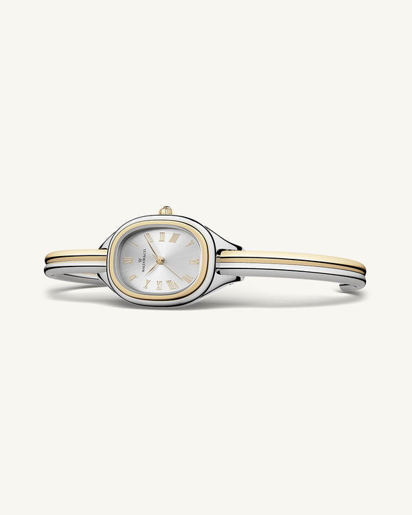 An ellipse shaped womens watch in Rhodium-plated 316L stainless steel from Waldor & Co. with silver sunray dial in brass. Mineral glass with sapphire crystal coating. Seiko movement. The model is Dual Bangle Watch.