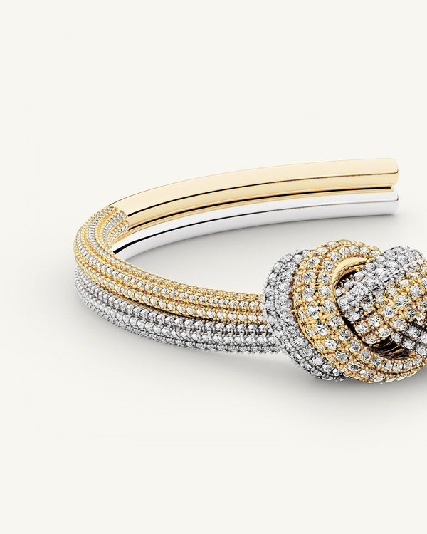 A Bangle in 14k-gold plated and silver polished copper from Waldor & Co. One size. The model is Dual Knot Bangle Pavè.