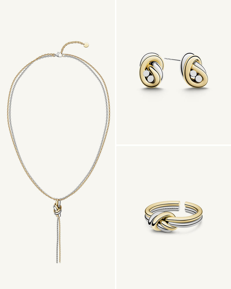 A polished stainless steel jewelry set in 14k gold from Waldor & Co. One size. The model is Dual Knot Ring.