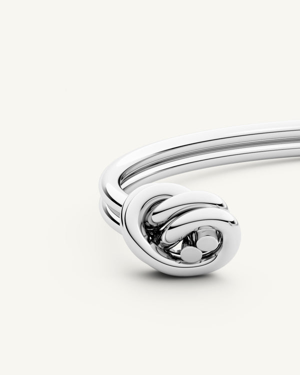 A Bangle Bracelet in polished Silver plated-316L stainless steel from Waldor & Co. The model is Dual Knot Twin Bangle Polished.