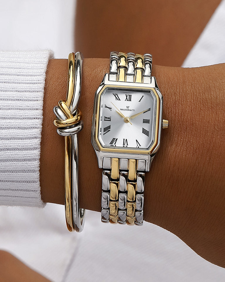 A square womens watch in 22k gold plated 316L stainless steel from Waldor & Co. with white Diamond Cut Sapphire Crystal glass dial. Seiko movement. The model is Eternal 22 Bellagio