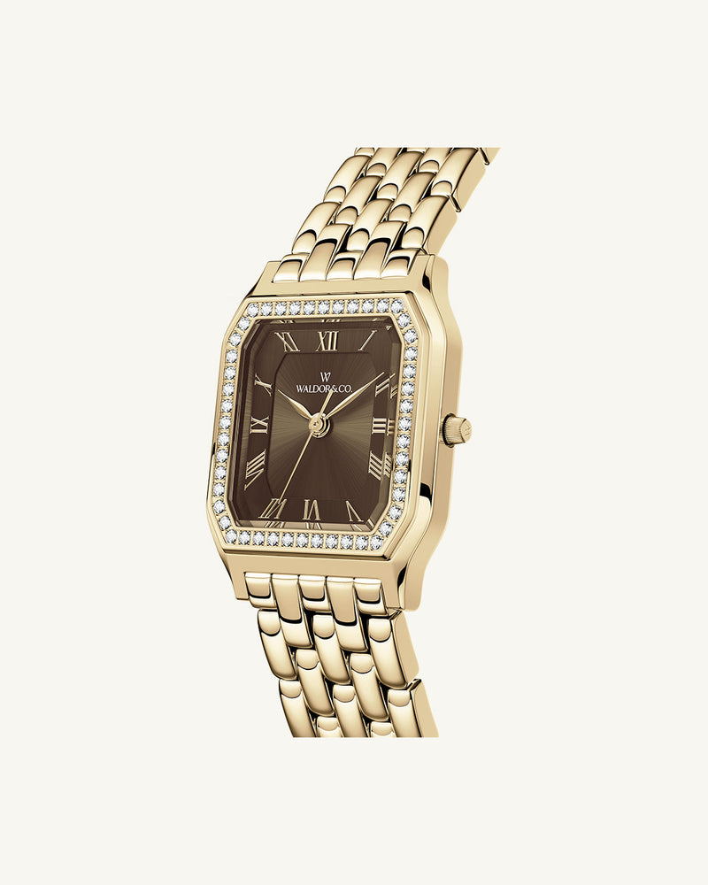 A square womens watch in Rhodium-plated 316L stainless steel from Waldor & Co. with a deep brown dial. Bezel with premium crystals. Diamond Cut Sapphire Crystal glass dial. Seiko movement. The model is Eternal 22 Bellagio Pavè.