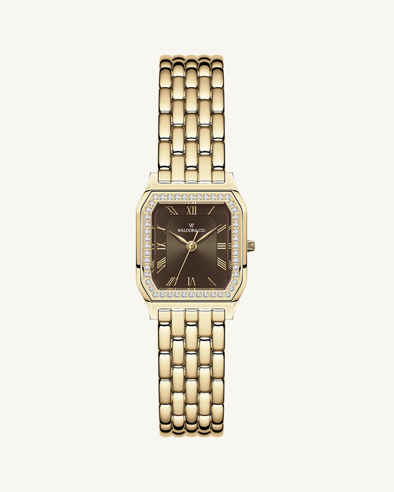 A square womens watch in Rhodium-plated 316L stainless steel from Waldor & Co. with a deep brown dial. Bezel with premium crystals. Diamond Cut Sapphire Crystal glass dial. Seiko movement. The model is Eternal 22 Bellagio Pavè.
