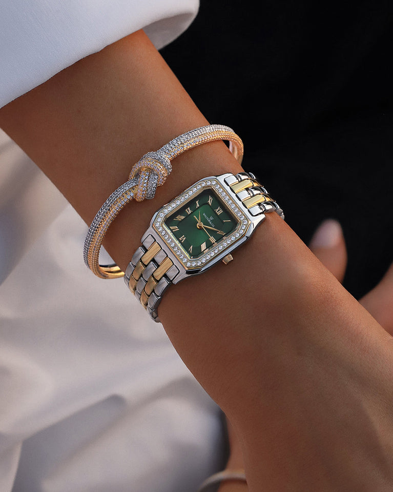  A square womens watch in Rhodium-plated 316L stainless steel from Waldor & Co. with emerald green dial. Bezel with premium crystals. Diamond Cut Sapphire Crystal glass dial. Seiko movement. The model is Eternal 22 Bellagio Pavè.