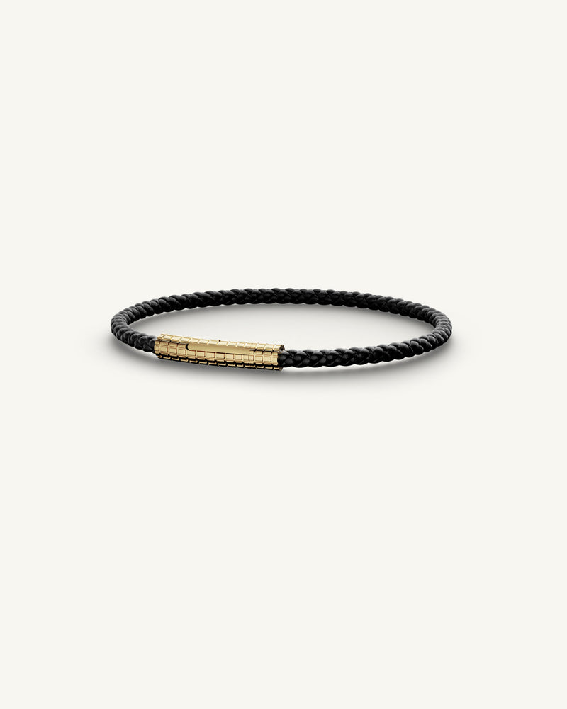 A Leather Bracelet in 14k gold-plated 316L stainless steel from Waldor & Co. The model is Grid Leather Bracelet Polished.