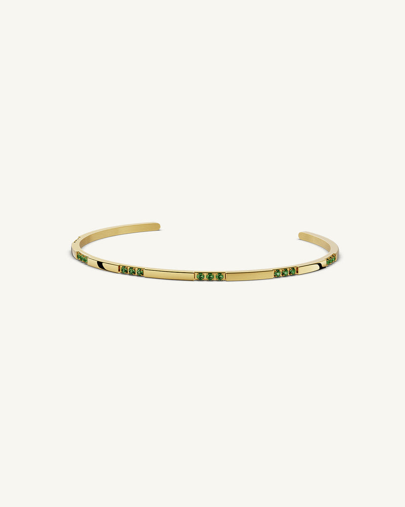 A Bangle in 14k gold-plated 316L stainless steel with green stones from Waldor & Co. One size. The model is Dulcet Bangle Polished.