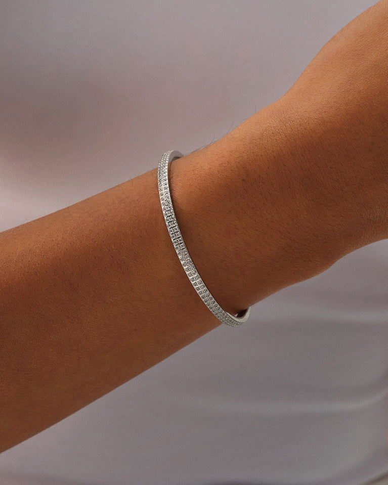 A Bangle Bracelet in polished Silver plated-316L stainless steel from Waldor & Co. The model is Pavé Bangle Polished.