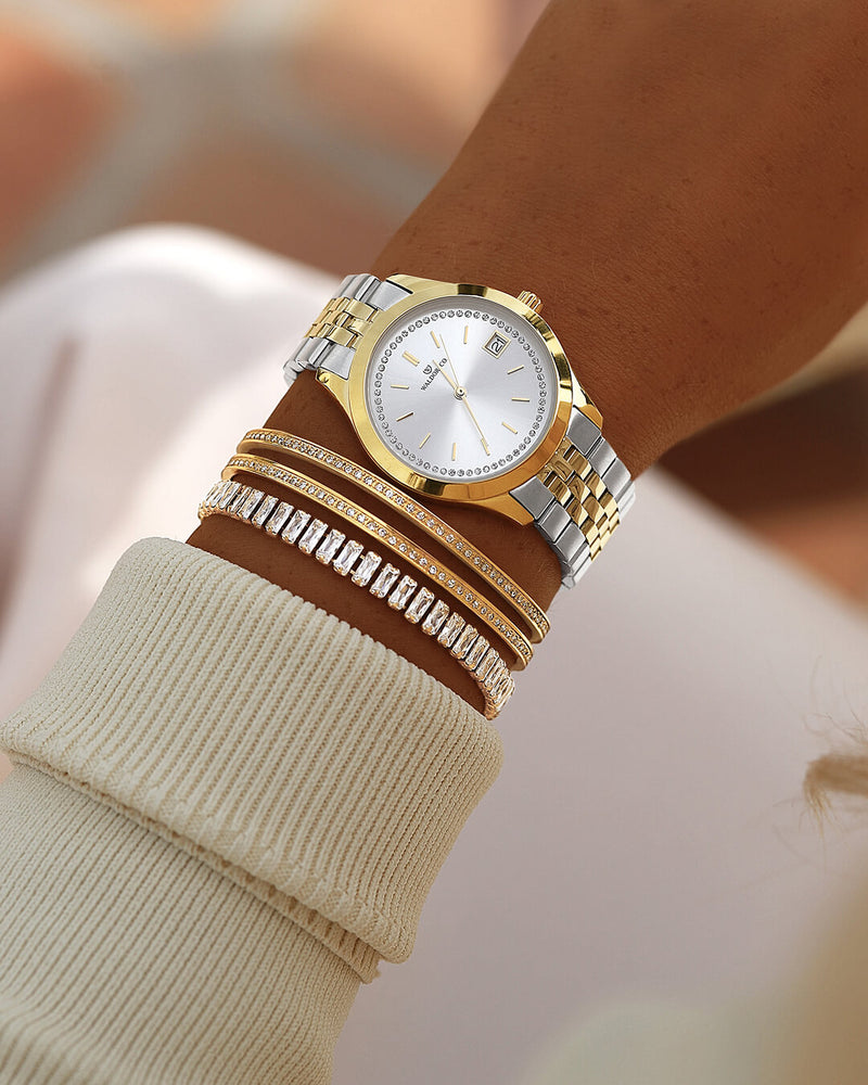 A round womens watch in 14k gold from Waldor & Co. with silver sunray dial and a second hand. Seiko movement. The model is Imperial 36 Roma 36mm.